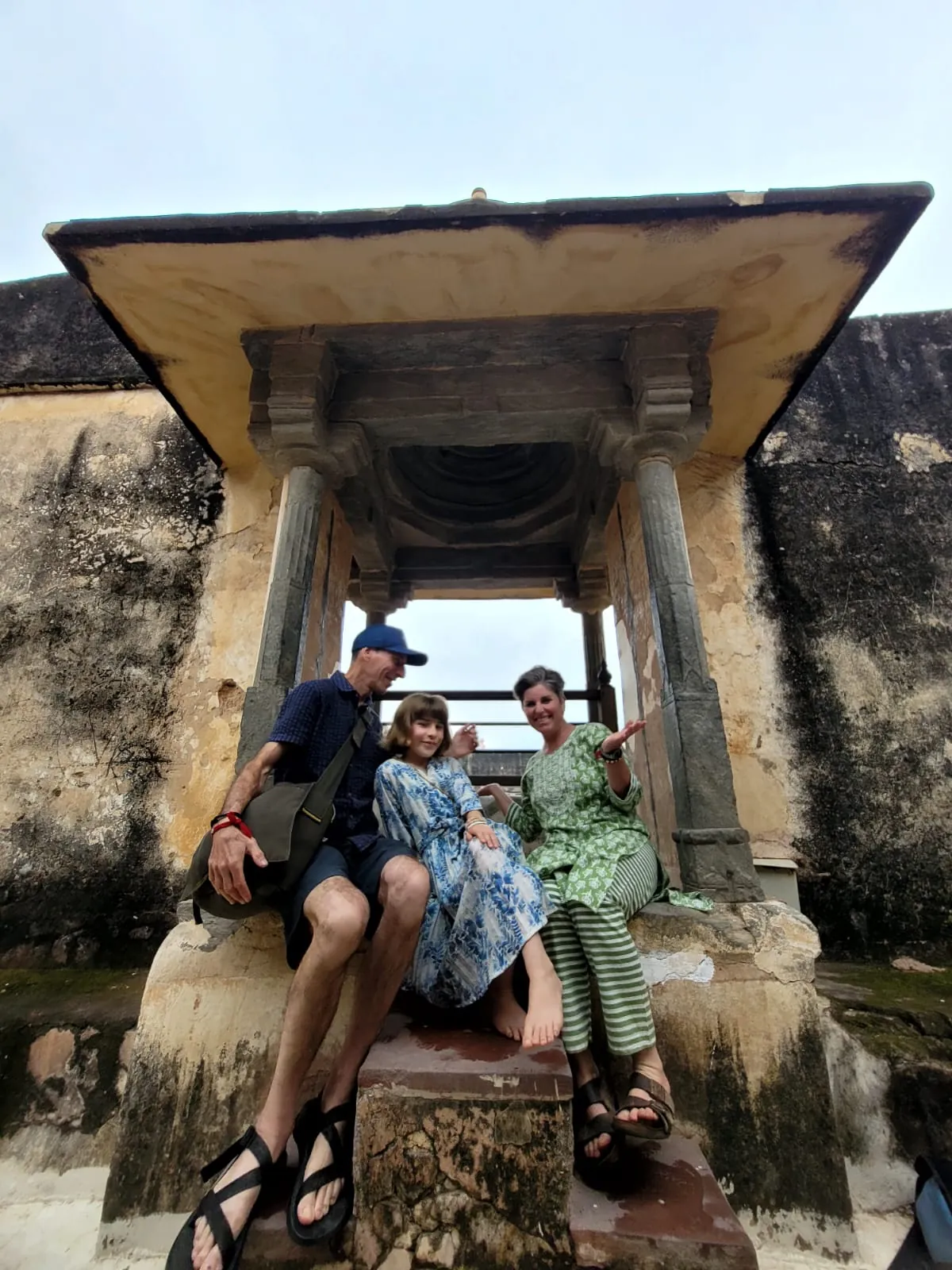 Family resting beneath a historic pavilion during a visit to Amber Fort in Jaipur