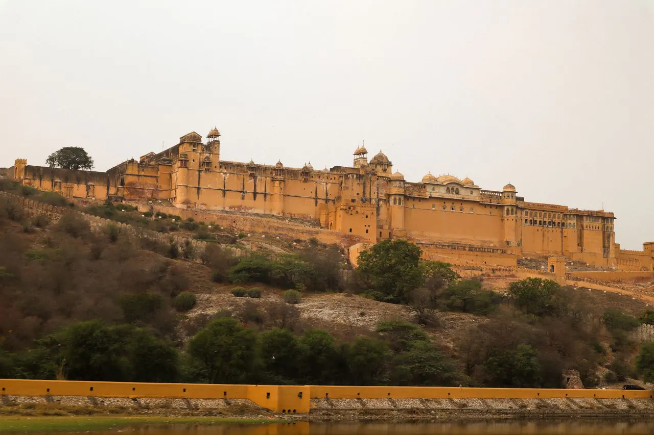 Amber Fort’s sandstone walls overlooking the hillside in Jaipur