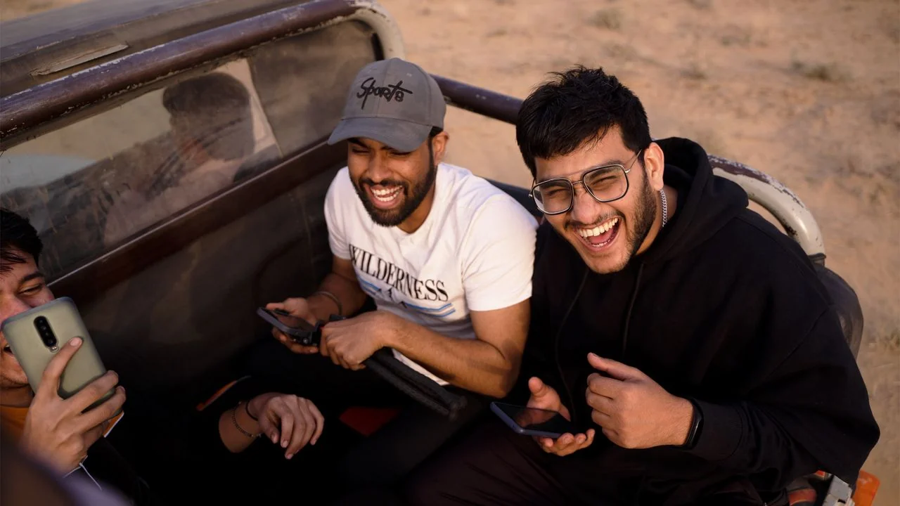 Smiling passengers seated in an open-top safari jeep