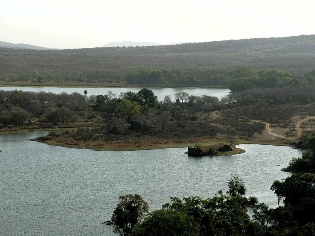 Elevated view of a lake with small wooded islands and hills beyond
