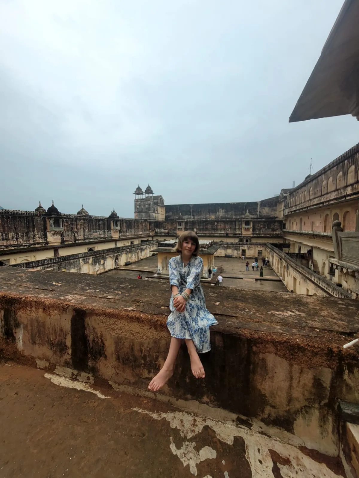 Visitor exploring a historic courtyard inside Amber Fort