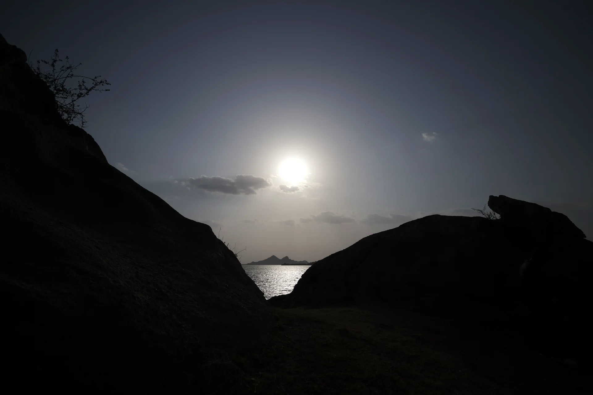 Sunset over Jawai Bandh between dark granite hills