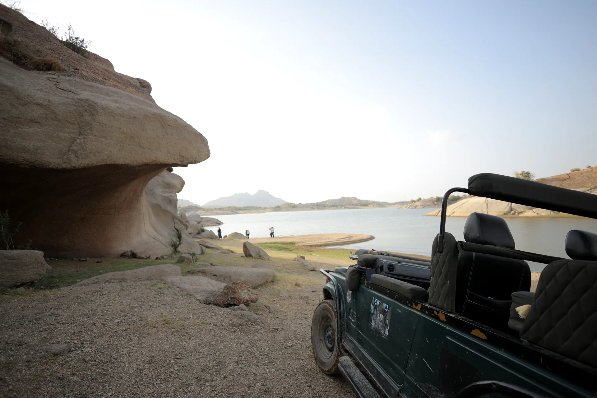 Open safari jeep beside a granite cave near Jawai Bandh