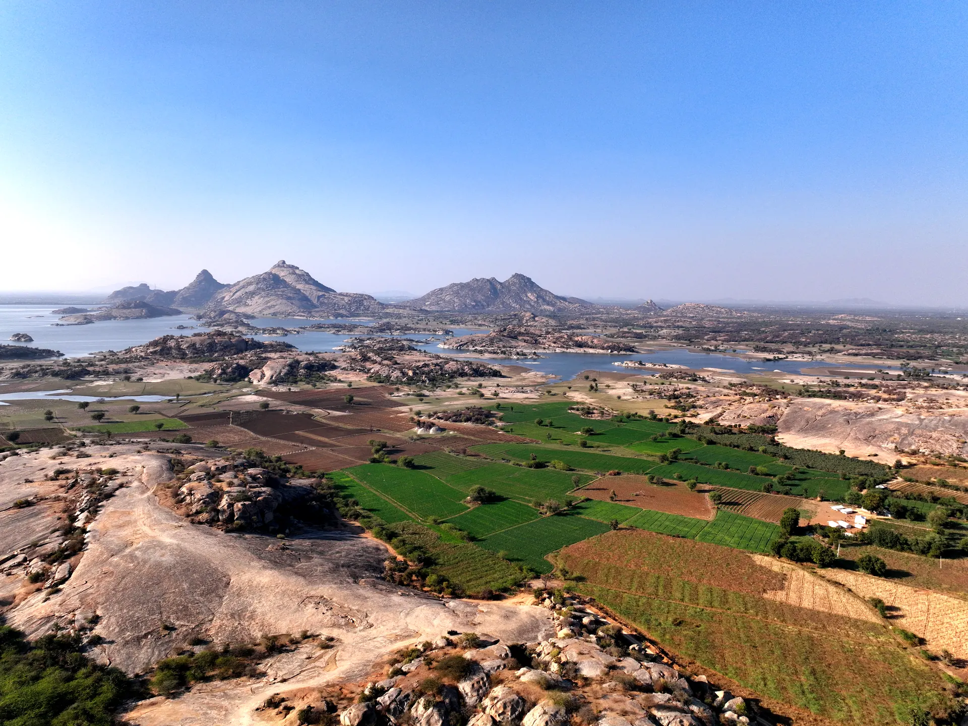 Aerial view of Jawai’s granite hills, farmland and reservoir