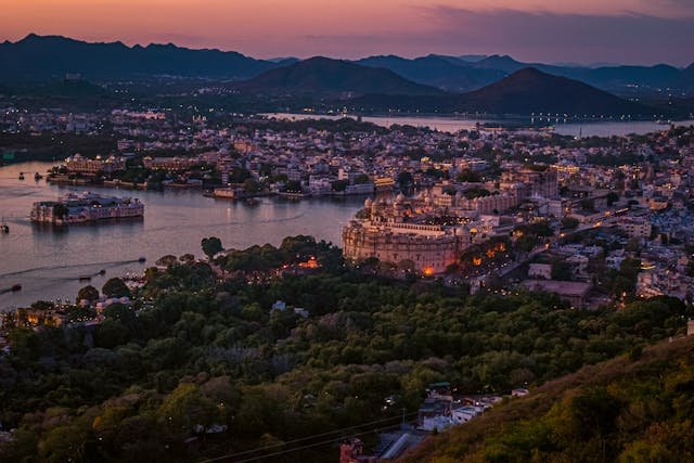 Udaipur city, lake and surrounding hills at dusk