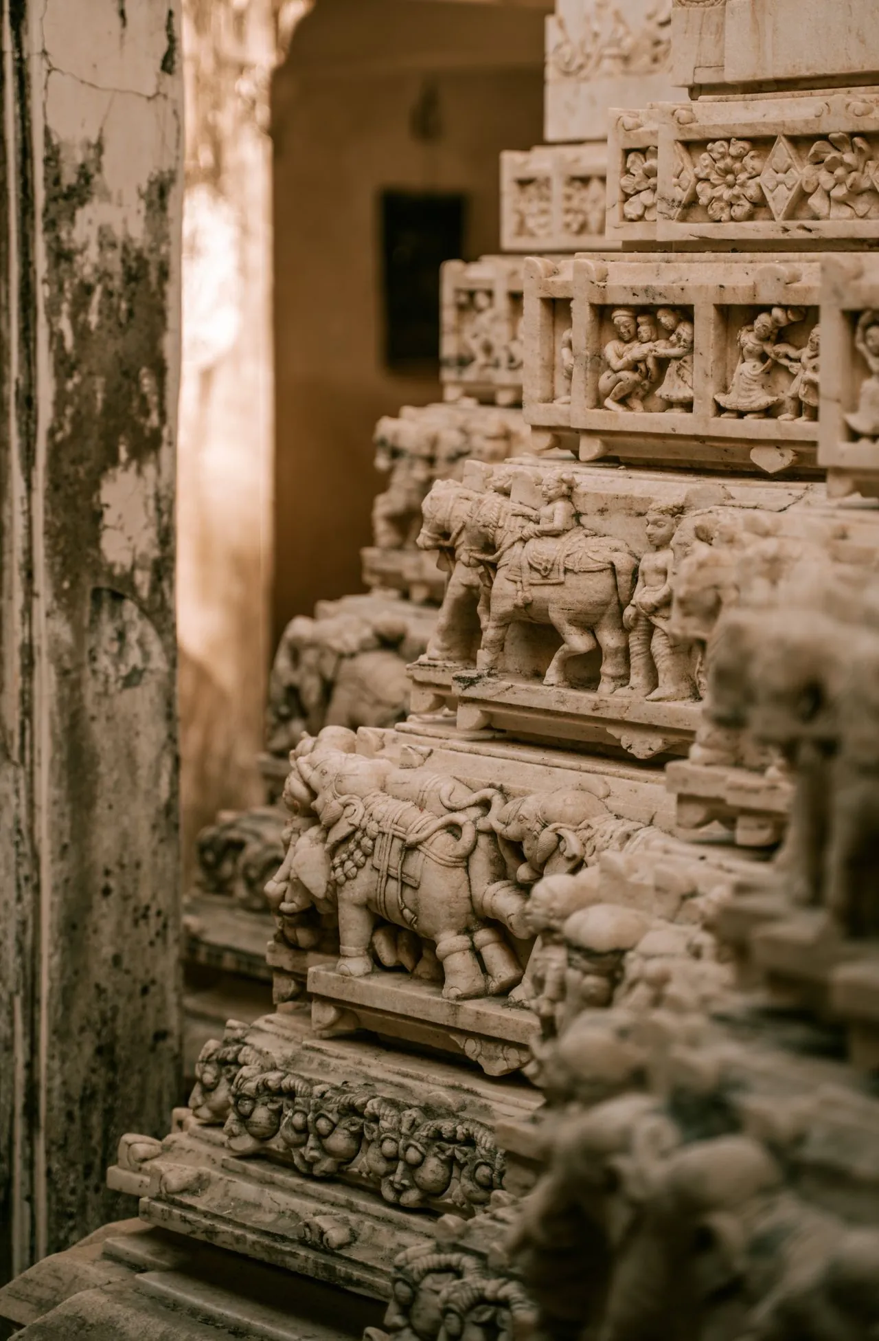 Intricate stone carvings of elephants and figures on a temple wall