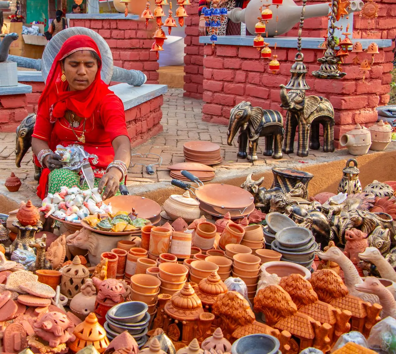 Local artisan selling traditional pottery in a Jaipur market