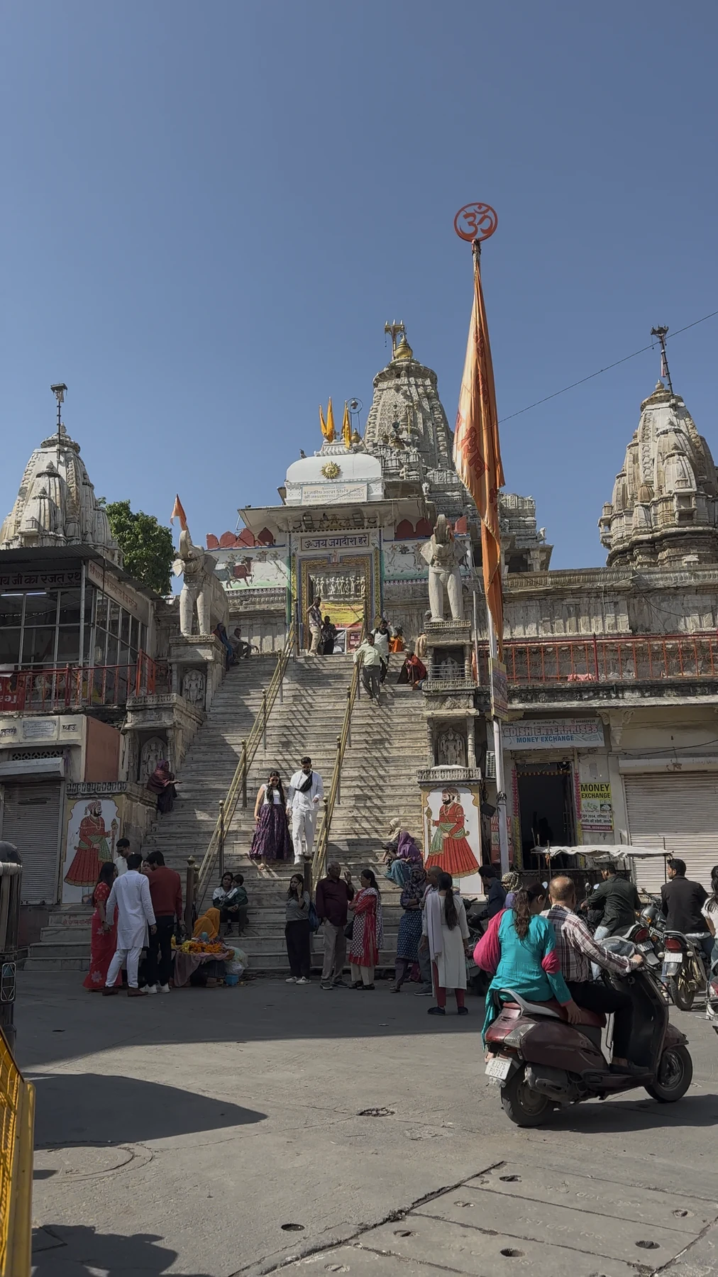 Steps leading to Jagdish Temple in Udaipur, with visitors near the entrance