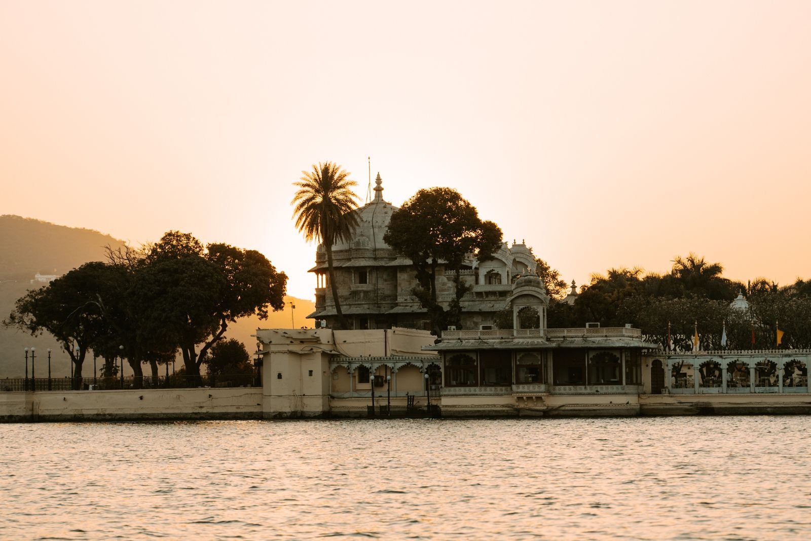 Heritage pavilion beside Lake Pichola during sunset